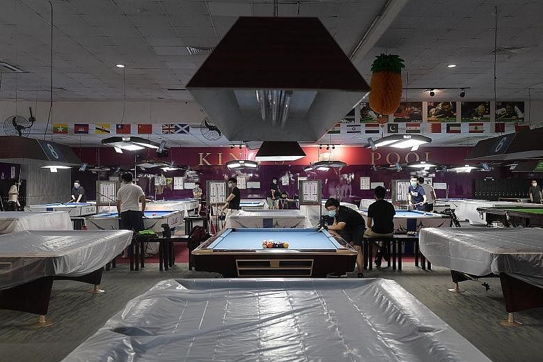 King's Pool in Ang Mo Kio Ave 3 yesterday at 1pm. Only 17 of its 28 pool tables and three out of five snooker tables can be used. ST PHOTO: ALPHONSUS CHERN