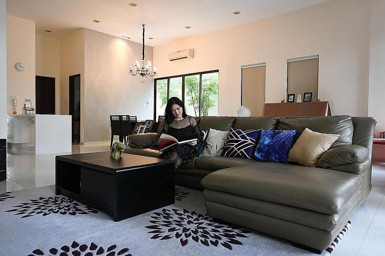 Ms Li in the living room of her Brockhampton Drive home, which has seven bedrooms, two of which are being used as study rooms.