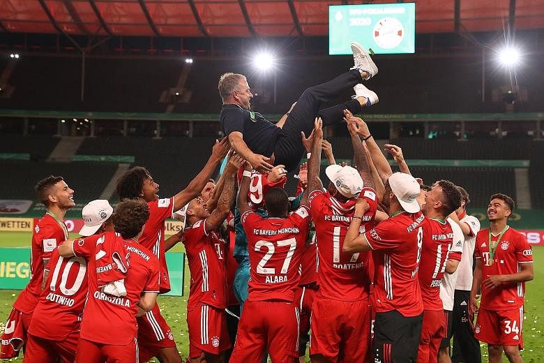 Bayern Munich coach Hansi Flick is tossed in the air by his players after they won the German Cup final against Bayer Leverkusen on Saturday.