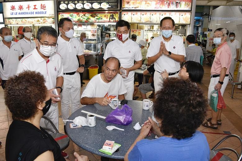 JALAN BESAR: Peoples Voice chief Lim Tean, who is leading his party's team in the GRC, speaking to patrons at Golden Mile Food Centre last Friday. MARINE PARADE:PAP candidates (from left) Edwin Tong, Mohd Fahmi Aliman, Tan Chuan-Jin and Tan See Leng 