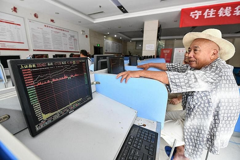 An investor monitoring stock market movements at a securities company in Fuyang, China's Anhui province, yesterday.