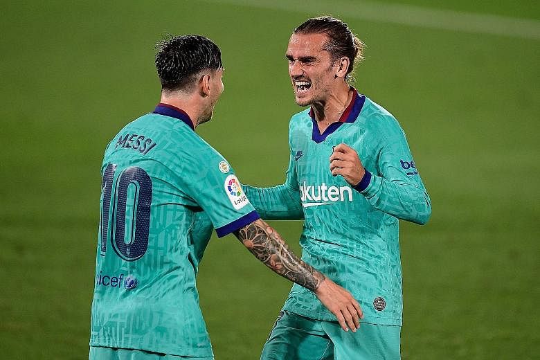Antoine Griezmann celebrating with captain Lionel Messi after scoring against Villarreal on Sunday. Barcelona won 4-1 but trail Real Madrid by four points. PHOTO: AGENCE FRANCE-PRESSE
