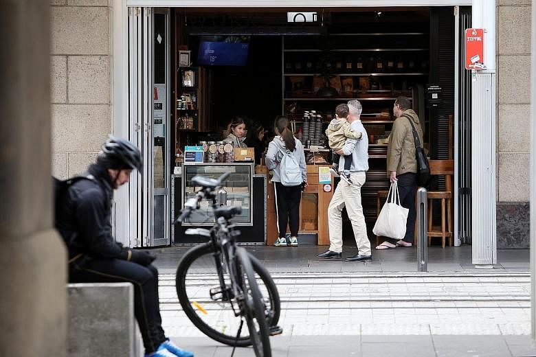 Customers at a cafe on George Street in Sydney. The pandemic is exposing generational fault lines that were set in train a decade ago when the financial crisis hit millennials hard and left Generation Z - described as those born after 1996 - with a l
