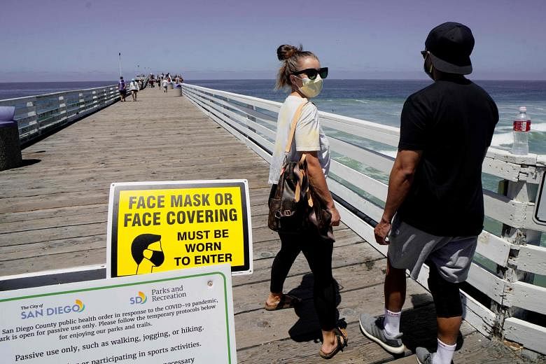 Beachgoers at the Pacific Beach Pier in San Diego, California, last Saturday. Many beaches across California have been shut down over the July 4 weekend due to a resurgence of Covid-19 cases. San Diego area beaches, however, have remained open. PHOTO