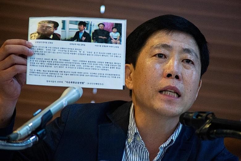 Mr Park Sang-hak, leader of the activist group Fighters for a Free North Korea, showing a propaganda leaflet while speaking about the release of fliers to North Korea at a press conference in Seoul on Monday. Mr Park Jung-oh, head of North Korean def