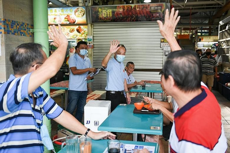 Former WP chief Low Thia Khiang being greeted by residents at Kaki Bukit Market and Food Centre on Sunday. The popular politician has been spotted walking the ground with his party's Aljunied GRC team. Ms Chan Hui Yuh, PAP candidate for Aljunied GRC,