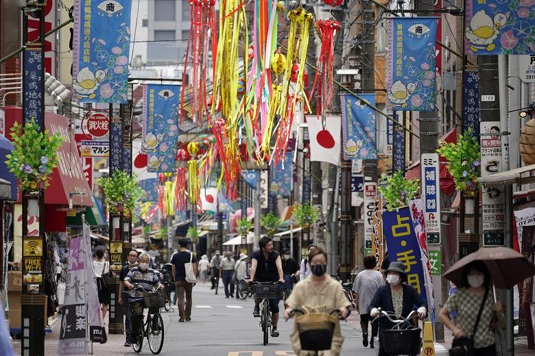 A shopping street in Tokyo last week. Japan saw large cuts in spending on hotels, transport and eating out in May as people stayed at home amid the Covid-19 pandemic, government data showed. On the other hand, stay-home policies boosted spending on p