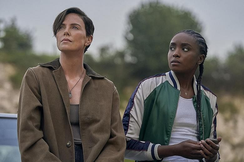 Keira Knightley (left) plays translator and linguist Katherine Gun in the biopic Official Secrets. Charlize Theron (above, left, with Kiki Layne) plays the leader of a secret clan of immortal warriors in The Old Guard.