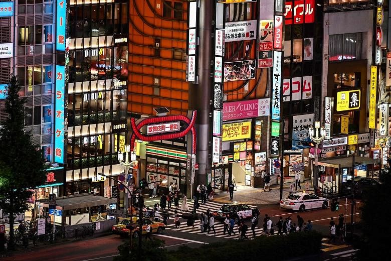The entertainment district of Kabukicho in Tokyo on June 24. The Tokyo metropolitan government will give $6,500 to nightclubs if they close for more than 10 days.
