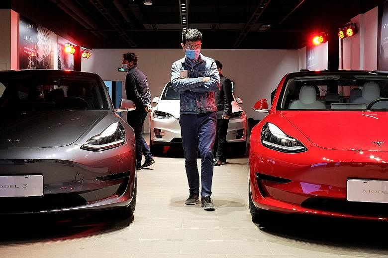 Tesla Model 3 sedans and a Model X sport utility vehicle at a showroom in Shanghai. The US carmaker's sales in China now approach a quarter of the total tally for electric vehicles, according to the country's Passenger Car Association, as wealthier b