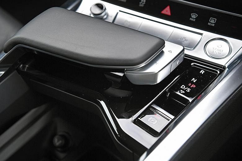 The stand-out feature of the Audi e-tron is the shift lever, which is actually a small thumb-operated slide clicker situated on a palm rest styled like a nautical throttle (above). It is pleasantly responsive, with not one instance of missed engagement.