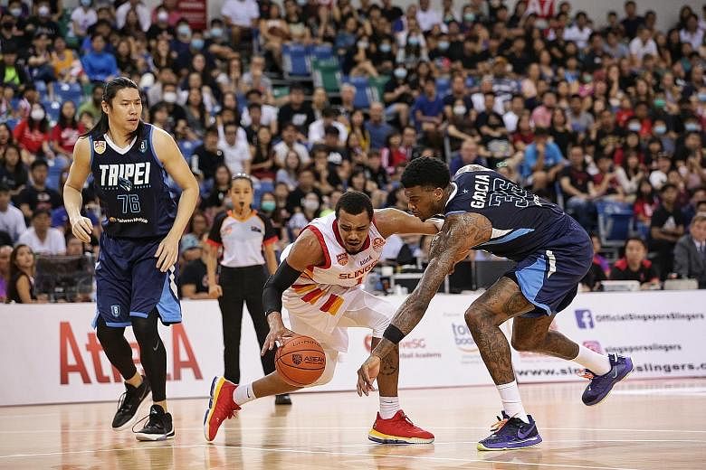 Singapore Slingers' Xavier Alexander (centre) taking on the Taipei Fubon Braves in February. Both teams are set to compete in the Asean Basketball League when the new season resumes next year.
