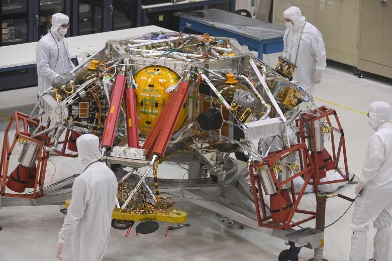 Above: Engineers and technicians examining the descent stage of the Mars 2020 spacecraft at Nasa's Jet Propulsion Laboratory in Pasadena, California, in a 2019 file photo.