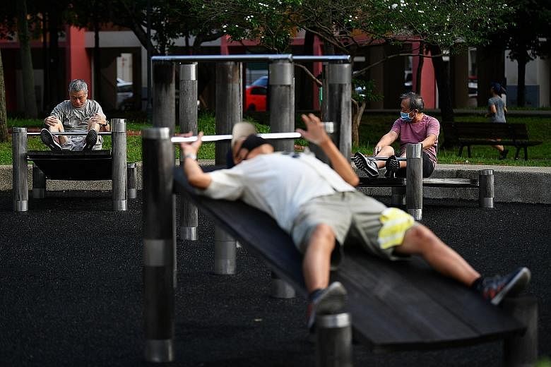 Several men exercising at Tampines Central Park during the first day of phase two of the reopening of the economy on June 19. Experts say that even if sports buffs had maintained their fitness levels during the two-month circuit breaker, returning to