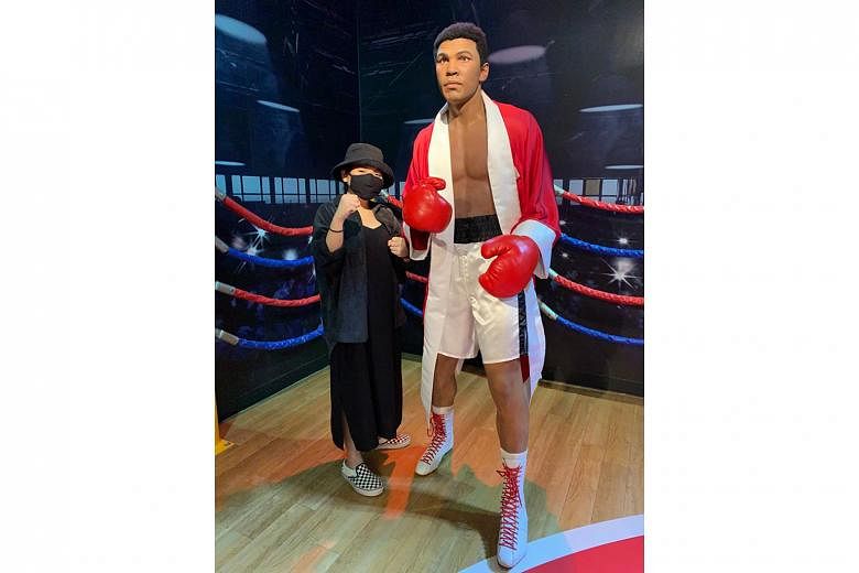 Ms Nur Diana, a first-time visitor to Madame Tussauds Singapore in Sentosa, posing with a wax statue of the late American boxer Muhammad Ali. 