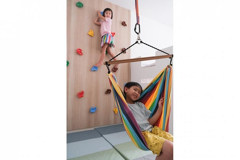Ms Fynn Sor fitted a rock wall, a trapeze bar and a hammock swing in the room of her children, Riley and Zachary. 