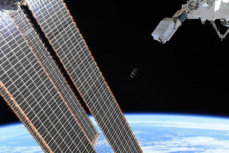 SpooQy-1 being ejected from the Japanese Small Satellite Orbital Deployer past the International Space Station's (ISS) solar arrays. This Nasa photograph was taken by an astronaut on the ISS.