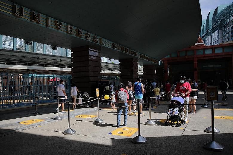 Visitors entering Universal Studios Singapore on July 4, about a month after the economy started reopening. Domestically, the dim outlook over a full resumption of tourism, weak retail sales and rising unemployment will continue to weigh down growth in th