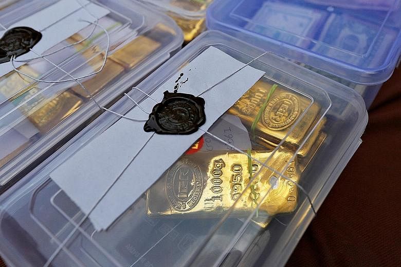 Seized gold bars on display at a police station in Ahmedabad city in India's western state of Gujarat in 2015. Gold smuggling is a major problem for the Indian authorities as the yellow metal is prized both as jewellery and as an investment for a rai