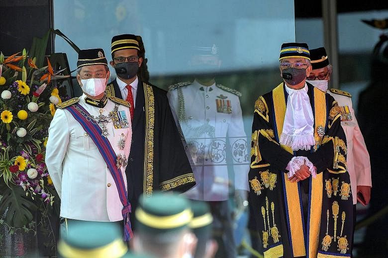 Prime Minister Muhyiddin Yassin (left) with Parliament Speaker Mohamad Ariff Yusof at the opening of Malaysia's Parliament on May 18. Tan Sri Muhyiddin limited the session to only a hearing of the King's opening speech, meaning a motion of no-confide
