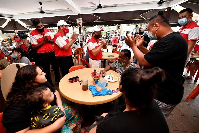 Right: Progress Singapore Party's West Coast GRC team members (from left) Nadarajah Loganathan, Jeffrey Khoo and Tan Cheng Bock greeting residents at a coffee shop in Teban Gardens yesterday. ST PHOTO: LIM YAOHUI