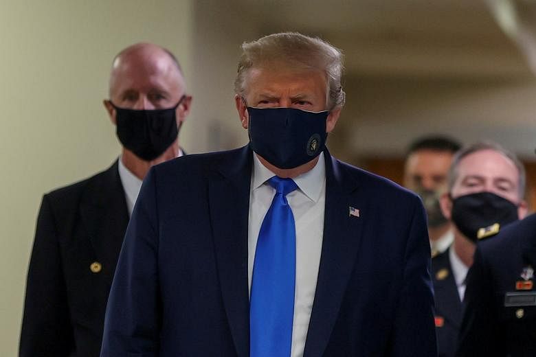 US President Donald Trump donning a face mask during his visit on Saturday to Walter Reed National Military Medical Centre outside Washington to meet wounded soldiers and front-line healthcare workers.