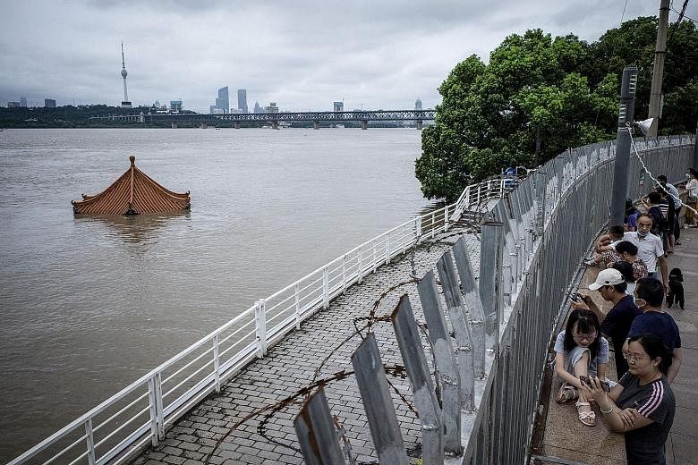 An inundated pavilion in the swollen Yangtze river in Wuhan on Sunday. Since last month, average precipitation in the river has reached the highest level since records began in 1961.
