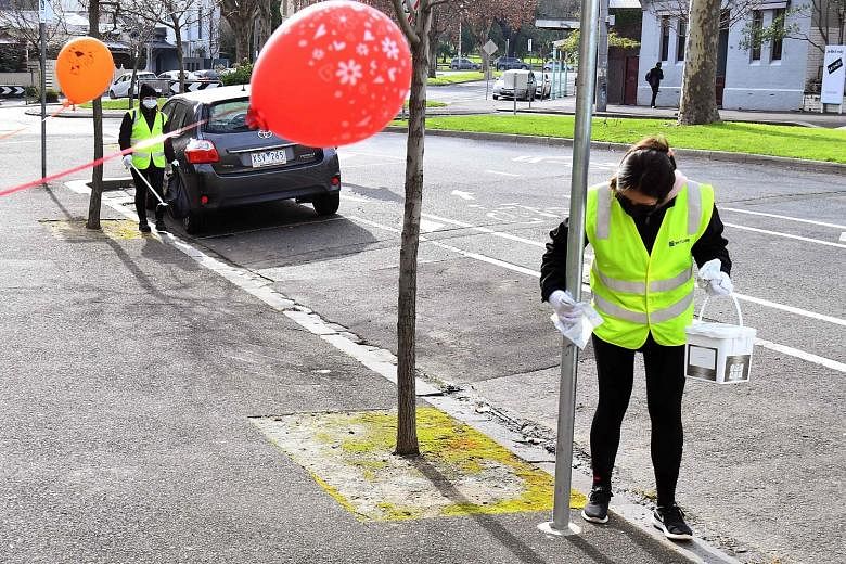 A cleaner wiping down a pole outside a public housing estate under lockdown in Melbourne. Yesterday, the authorities in Victoria reported 177 new coronavirus cases in the past 24 hours, the eighth consecutive day that the state has seen triple-digit 