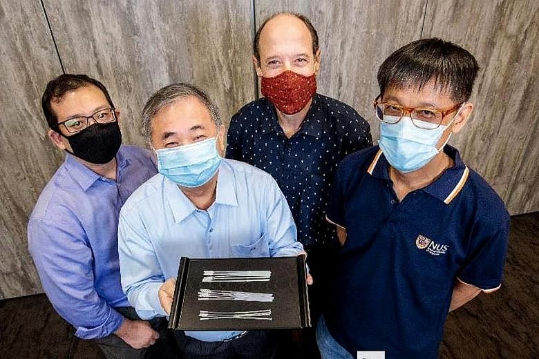Professor Freddy Boey with the swabs. With him are (from left) Dr Alfred Chia, Associate Professor David Allen and Associate Professor Yen Ching-Chiuan. They are part of two National University of Singapore teams that came up with three nasopharyngea