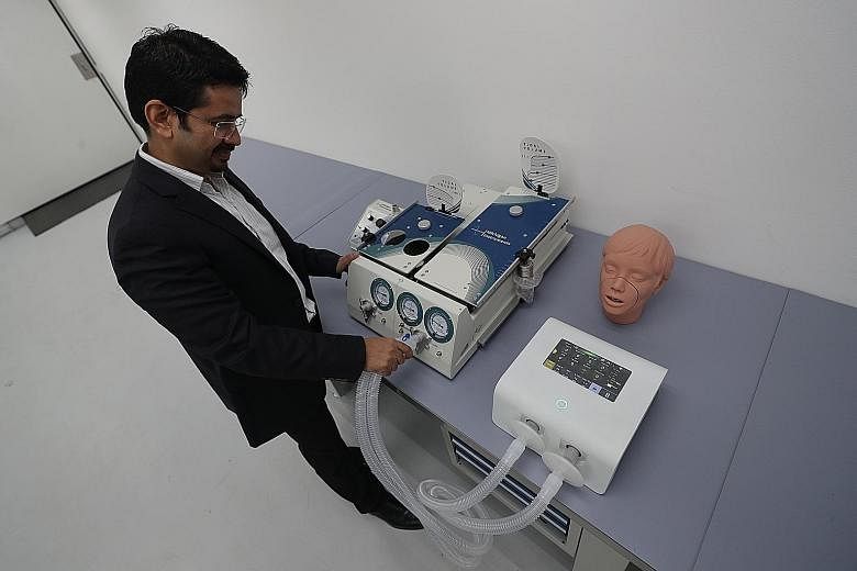 Above: ABM Respiratory Care's chief executive Vinay Joshi with the Alpha ventilator at Advanced MedTech's Tuas facility. The ventilator is converted from ABM Respiratory Care's FDA-approved respiratory device. Left: Advanced MedTech's technicians and