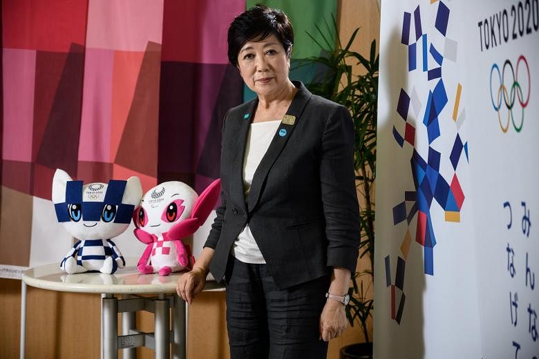 Hosting the Olympics next year is a sign of world unity, says Tokyo Governor Yuriko Koike, with Games mascots Miraitowa and Someity.