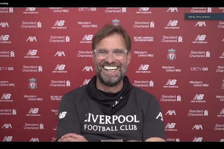 Right: Liverpool's Virgil van Dijk and Mohamed Salah warming up before a match. The Egyptian star is one of the key contributors to the Reds' first English title in 30 years. Below: Liverpool manager Jurgen Klopp addresses the media at a virtual pres