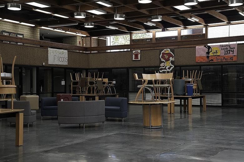 Empty chairs and tables at Torrey Pines High School last Friday in San Diego in America's most populous state of California. The public school districts for Los Angeles and San Diego said they will teach only online when classes resume next month, ci