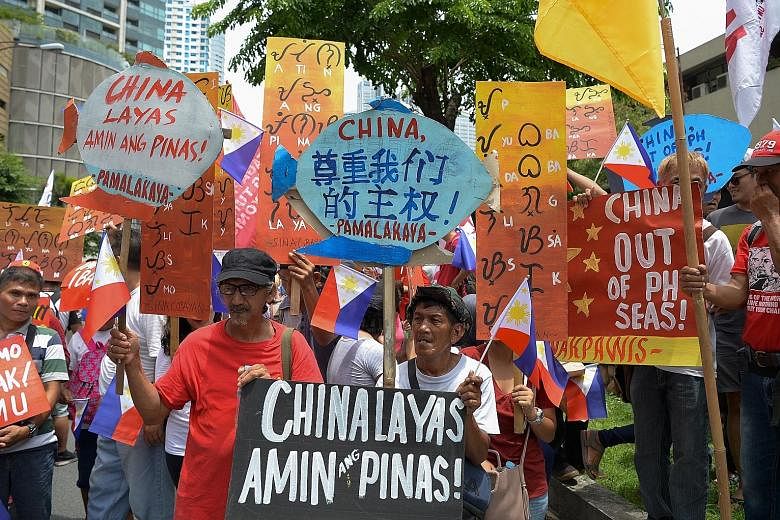 Activists holding placards with anti-China slogans during a protest in front of the Chinese consulate in Manila last year. The Philippines is contesting China's claims over waters it considers part of its exclusive economic zone. China's vast claims 