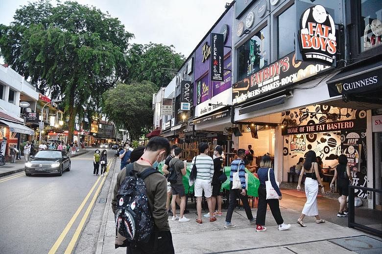 Thinner crowds in Lorong Mambong in Holland Village last Saturday. Regulars told The Straits Times that the safe distancing measures have improved their dining experience since the start of phase two of Singapore's reopening on June 19.
