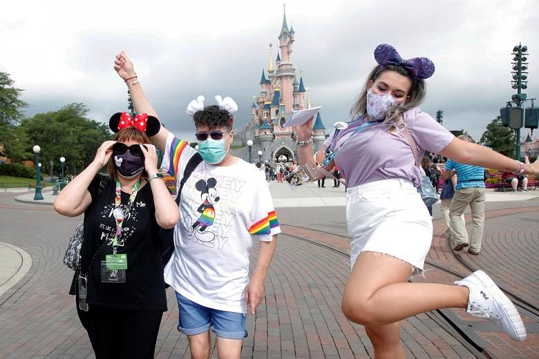 Some of the first visitors arriving at Disneyland Paris yesterday as the theme park in Marne-la-Vallee, near Paris, reopened its doors to the public after being shut for four months. As festive music played, Mickey Mouse, Pluto and other Disney chara