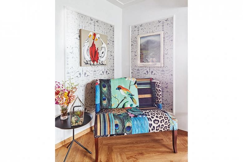 Art features prominently throughout the apartment, such as in this corner, which is also furnished with a quirky two-seater chair. 