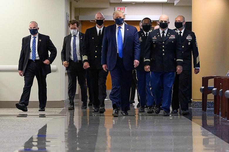 President Donald Trump visiting Walter Reed National Military Medical Centre in Bethesda, Maryland, on July 11, wearing a mask for the first time since the Covid-19 outbreak. Wearing a mask in the US has been described as a political issue, not a med