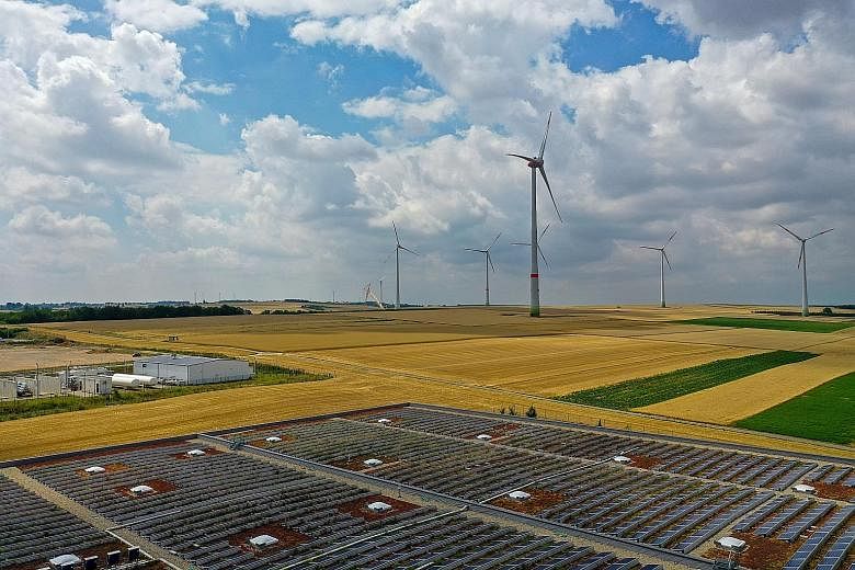 Solar panels and wind turbines in Mainz, Germany. Advocates of "green recoveries" are lobbying governments to pivot to a low-carbon path, encouraged by early support for climate-friendlier stimulus in places like Germany.