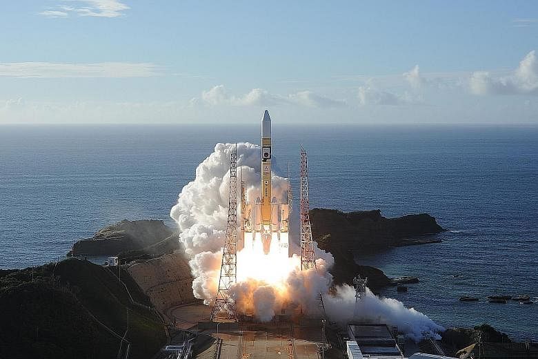 In this handout photo taken yesterday by Mitsubishi Heavy Industries, an H-2A rocket carrying the unmanned Al-Amal (or Hope) probe is seen blasting off from Tanegashima Space Centre in southern Japan.