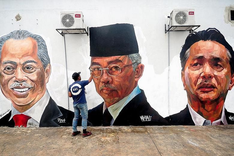 Murals on the walls of a housing estate in Selangor, depicting Malaysian leaders such as (from far left) Prime Minister Muhyiddin Yassin, the Malaysian King and Health Ministry director-general Noor Hisham Abdullah, were found vandalised yesterday. C