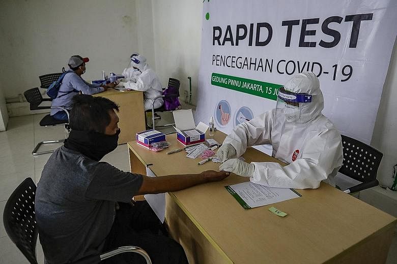 Health workers collecting samples during a rapid test for coronavirus in Jakarta last Wednesday. Post-market surveillance on rapid antibody test brands done by the Association of Indonesia's Clinical Pathology and Laboratory Medicine specialists show
