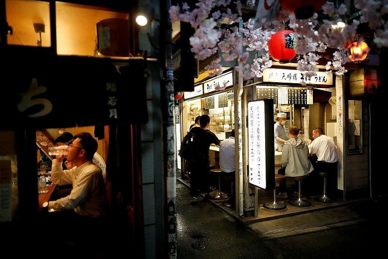Patrons at bars in Tokyo's Shinjuku district in May, after the state of emergency was lifted. The government is reported to be considering more spot checks of nightlife businesses. But concern is growing that the industry has been made a scapegoat fo