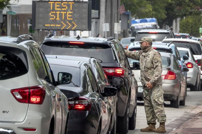 People waiting in their cars to get tested for Covid-19 by the Florida Army National Guard last week. The military is working with the Miami Beach authorities and the Florida Department of Health to test people as infections in the state soar. PHOTO: