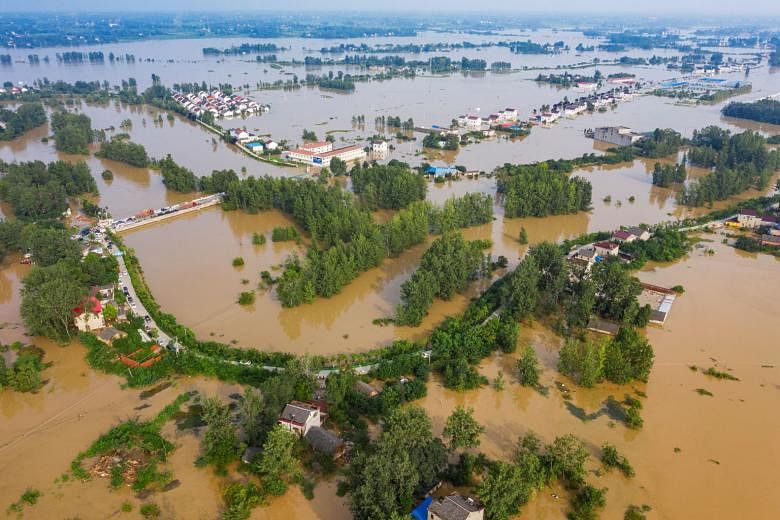 A flooded town in Luan, China's Anhui province, on Monday. While drones, intelligent patrol systems as well as other smart technologies have been used to support China's flood control efforts, ancient methods like the beating of gongs remain importan