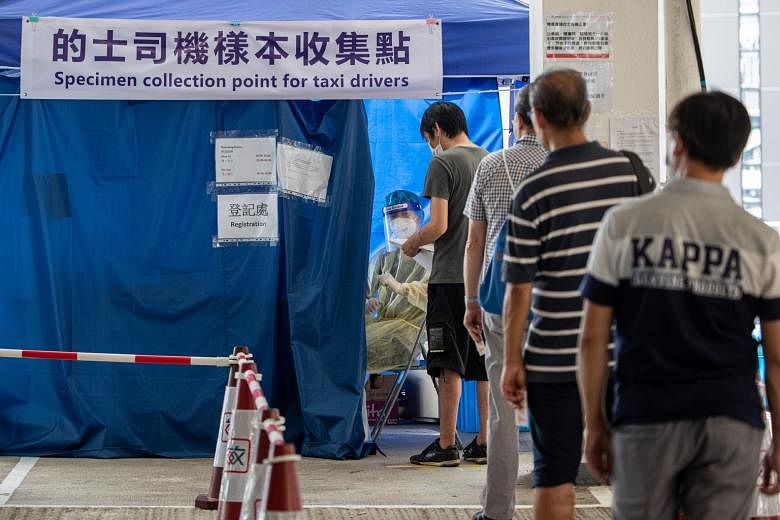 Taxi drivers waiting to be tested for the coronavirus in Hong Kong on Sunday. Covid-19 cases in the city crossed the 2,000 mark yesterday, with two more people dying from the disease. PHOTO: EPA-EFE