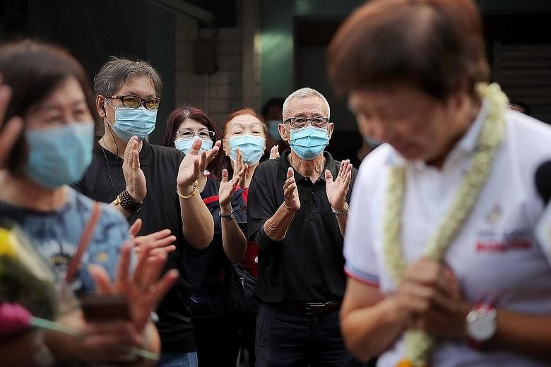 Former MP Lee Bee Wah (right) tearing up while greeting residents at Block 848 Yishun Ring Road on July 5. ST PHOTO: GAVIN FOO