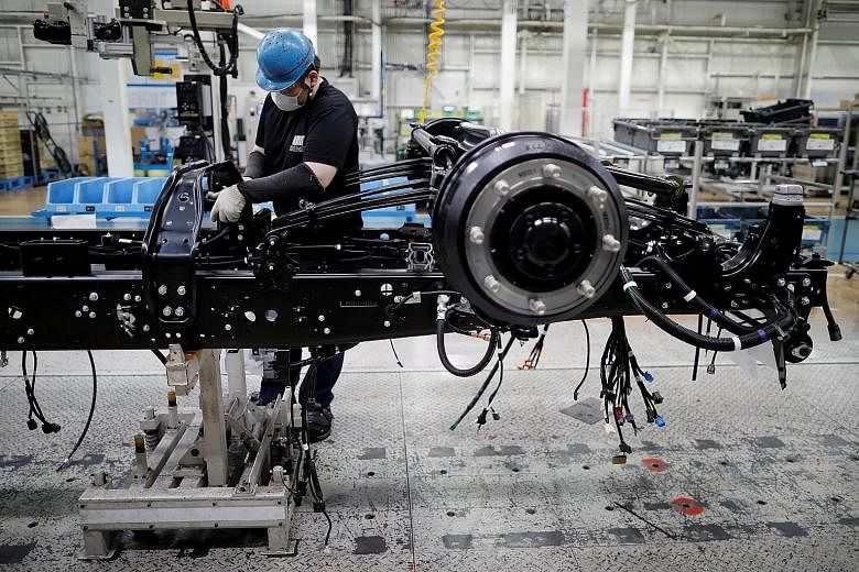 An employee working on the assembly line at the Kawasaki factory of Mitsubishi Fuso Truck and Bus Corp in Kawasaki, south of Tokyo, in May. Japan's economy is forecast to shrink 5.3 per cent this fiscal year.