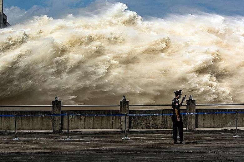 Water being released from China's Three Gorges Dam on Sunday to relieve flood pressure in Yichang city in the central province of Hubei. Officials from China's Water Resources Ministry said the dam, which has been storing huge volumes of water to eas
