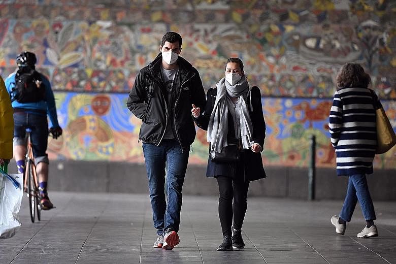 Commuters in Melbourne yesterday, the first day of the mandatory wearing of face masks in public areas. The pandemic has drastically reversed Australia's fortunes as it experiences its highest debt levels since the Second World War. PHOTO: AGENCE FRA